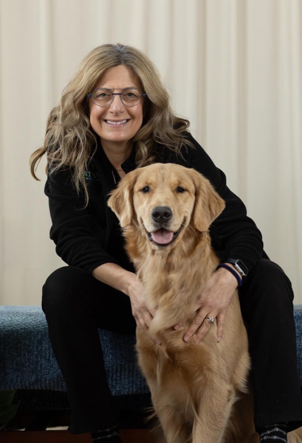 Dr. Gray with a golden retriever
